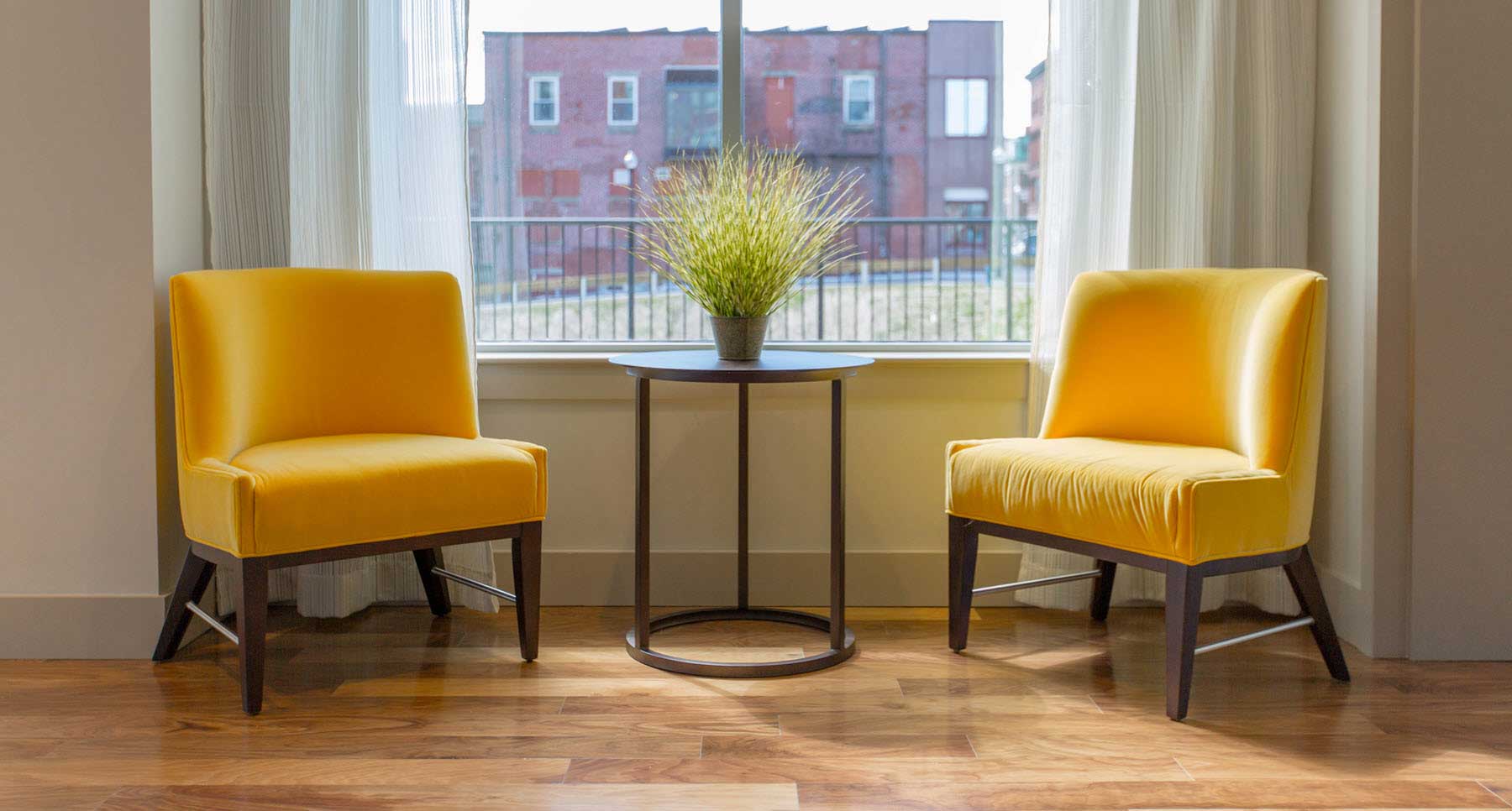 two yellow chairs facing each other ready for a professional counseling session