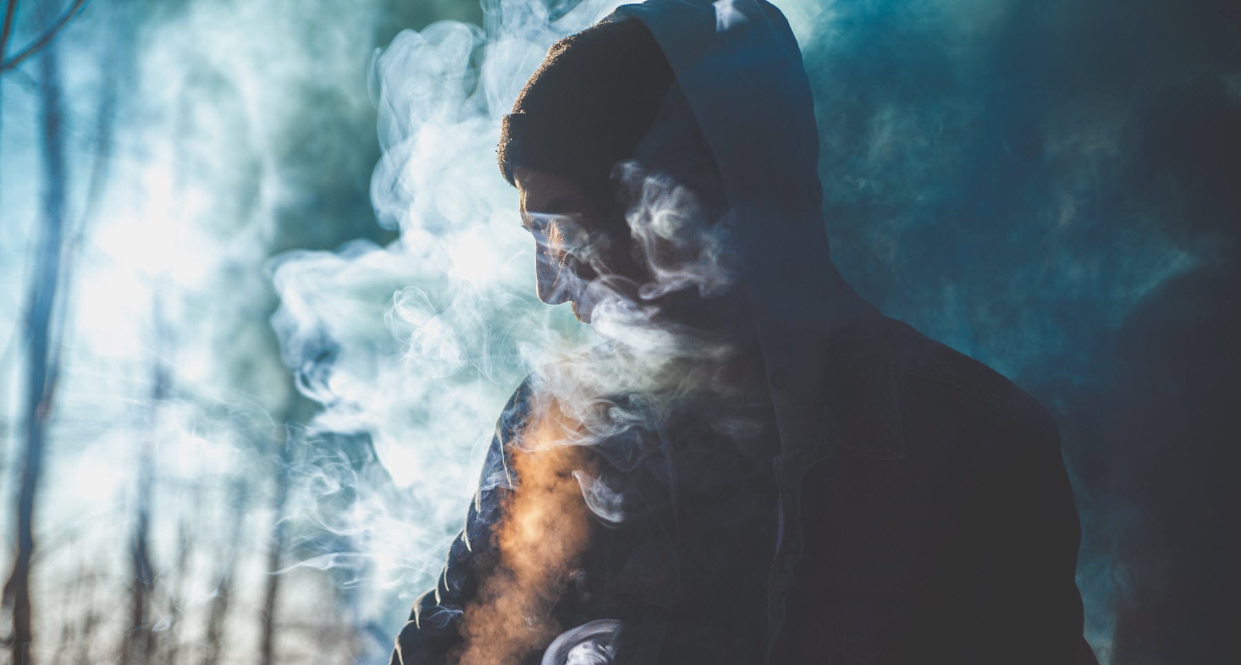 guy outside surrounded by smoke because he has an addiction to heroine