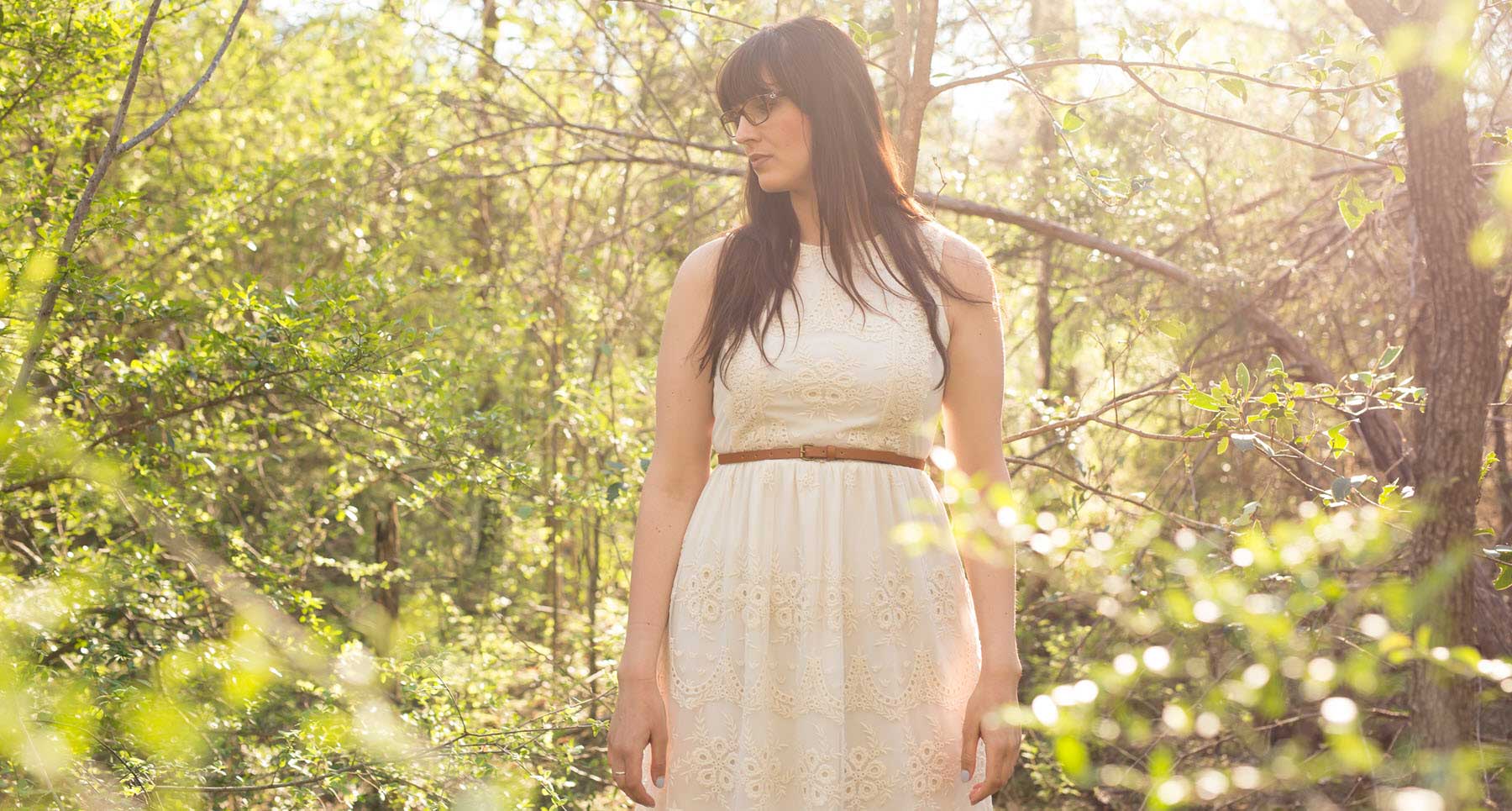 woman standing outside in a white dress struggling with fears and anxiety