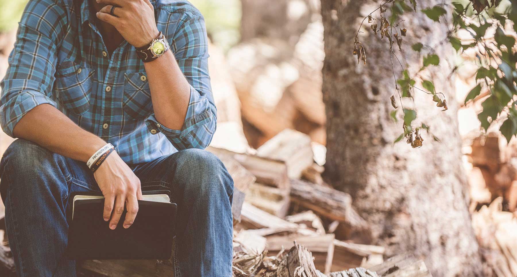 reading bible outside struggling with depression and anxiety pastor attempted suicide