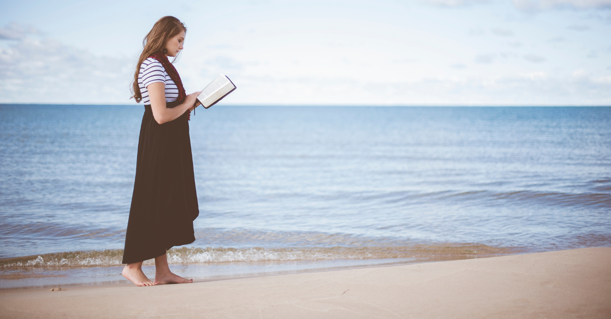 Young woman reading bible on beach 3 Encouraging Bible Verses to Start the New Year with Faith