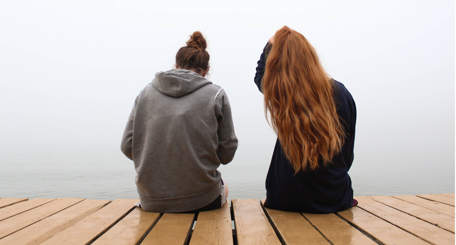 TheHopeLine Resources two girls sitting on a dock help a best friend with a breakup