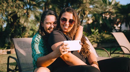 Two girls smiling taking a selfie